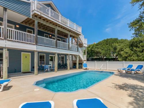 a swimming pool in front of a house at 2072 - Laughing Duck in Duck