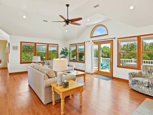 a living room with a couch and a ceiling fan at 2072 - Laughing Duck in Duck