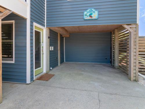 a garage door on a house with a driveway at 2072 - Laughing Duck in Duck