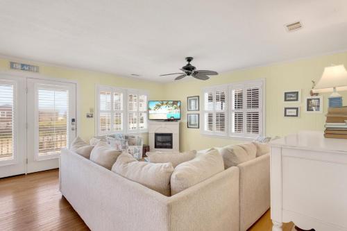 a living room with a couch and a tv at 4018 - Shorely Bliss in Kitty Hawk