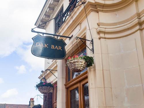a dark bar sign on the side of a building at The Eastbrook Pub & Hotel in Dagenham