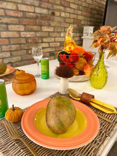 a table with a plate with a melon on it at Varázslakos Tanya in Soltvadkert