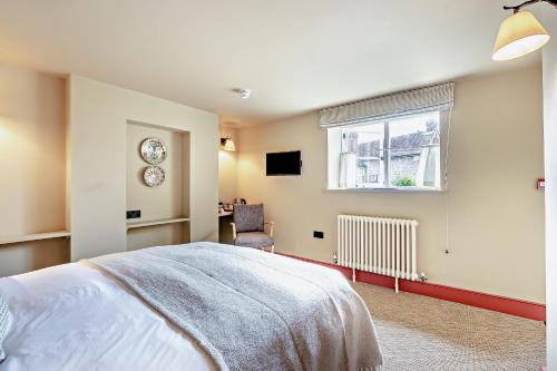 a bedroom with a bed and a window and a desk at Cub Bedroom Five in Eastdean