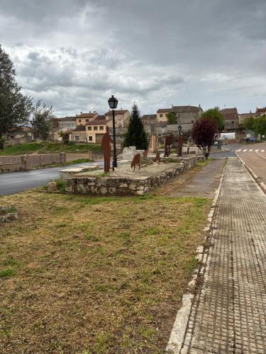 a street with a cemetery and a street light on the side of a road at El Mirador de la Sierra Y Casa Rosmari in Urueñas