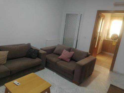 a living room with two couches and a coffee table at S2 JDC jardin de carthage in Tunis