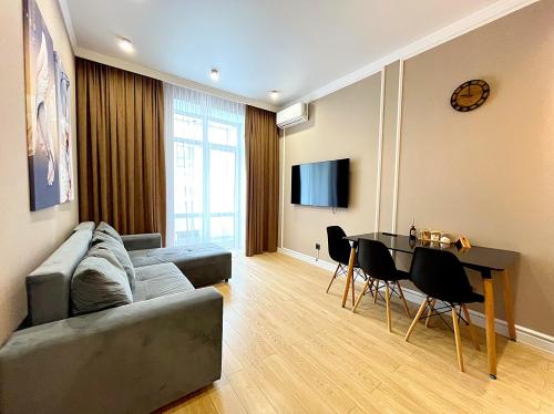 a living room with a couch and a table at Новая Евродвушка на Левом берегу Астаны, Экспо, МегаСилквэй in Astana