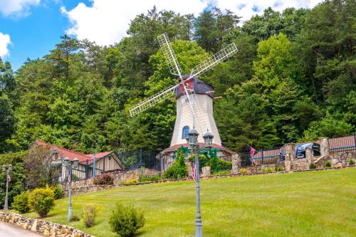a windmill in the middle of a green field at Bears Cove in Sautee Nacoochee