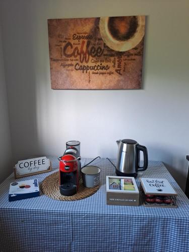 a table with a table cloth with a coffee maker on it at La Casa di Simone in SantʼAmbrogio di Torino
