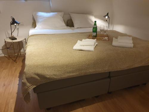 a bedroom with a bed with two towels on it at Boutique Hotel Villa Horbach in Idar-Oberstein