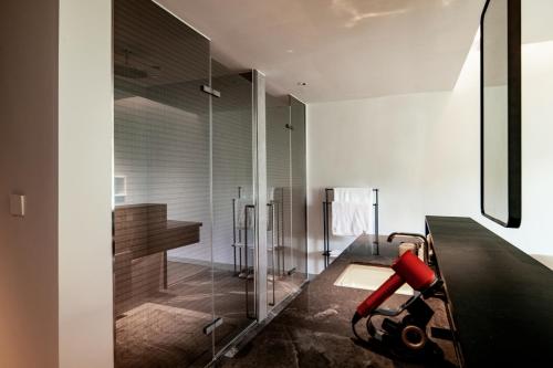 a bathroom with a shower with a bench and a desk at 至也 黄果树 in Xinggong