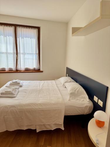 una camera da letto con un letto grande e una finestra di Accogliente Appartamento nel Centro Storico di Belluno, dietro Piazza delle Erbe a Belluno