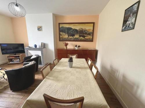 a dining room with a table and chairs and a television at Terrenave in Escource