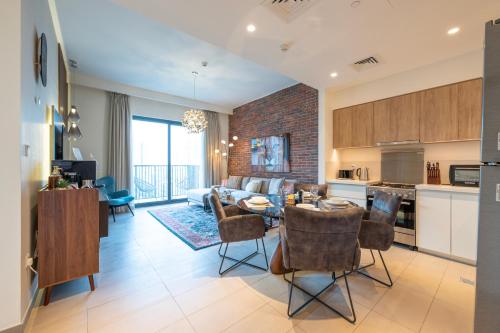 a kitchen and living room with a table and chairs at Designer 1 Bedroom Apartments in Dubai Hills Estate in Dubai