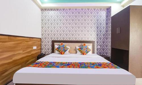 a bedroom with a large bed in a room at FabExpress Sumangal in Gwalior
