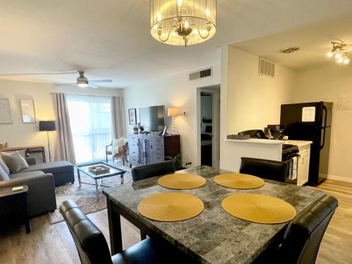 a living room with a dining room table with chairs at Shortest Walk to Shands and UF Health - Quiet, Equipped, Reliable - Free Parking in Gainesville