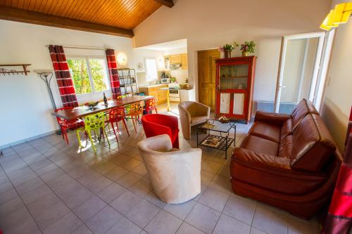 a living room with a couch and a table at Les Villas de Perret in Joyeuse