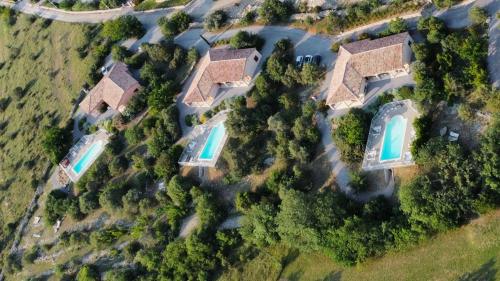 an overhead view of a house with two swimming pools at Les Villas de Perret in Joyeuse