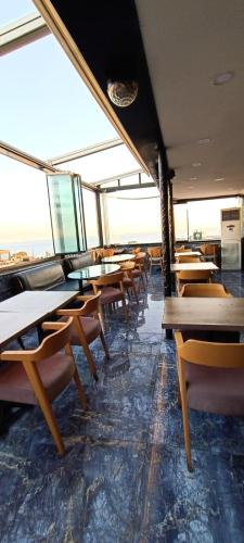 a dining room with tables and chairs in a building at RoyalBoutique Hotel Anex B KayaRoyal - There is No Lift - All Coffees & Tea Free Of Charge At The Terrace Restaurant in Istanbul