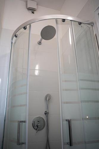 a shower in a bathroom with a glass door at la casa di fatima in Campoleone