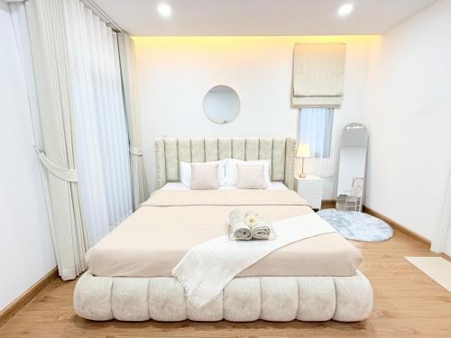 a bedroom with a large bed with towels on it at CORNER STAY 210 Hatyai in Sathani Khlong Rian