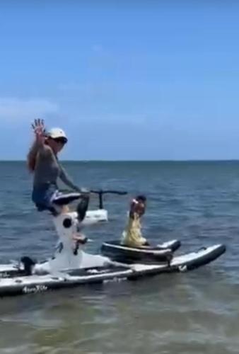 two people on a paddle board in the water at Sea Breeze inn in Providencia