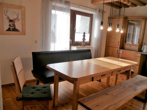 a dining room with a wooden table and a chair at Ferienhaus Kirchl in Hohenau