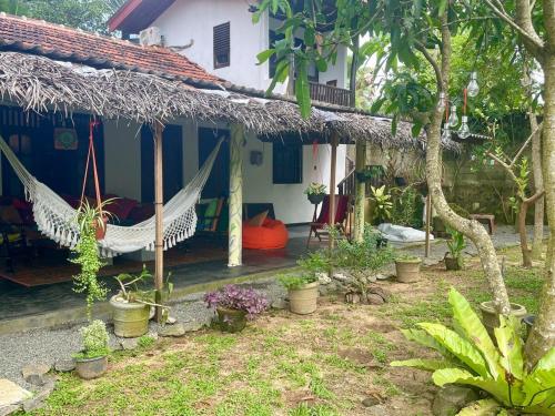 a house with a hammock in front of it at DNA secret palace in Tangalle