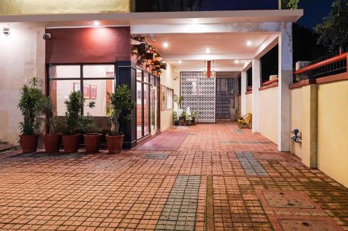 an empty alley with potted plants in a building at FabHotel The Dayal - 24 kms from Delhi Gate, 5 kms from Agra Fort in Agra