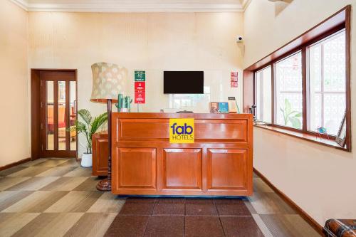 an office with a desk with a tv on the wall at FabHotel The Dayal - 24 kms from Delhi Gate, 5 kms from Agra Fort in Agra