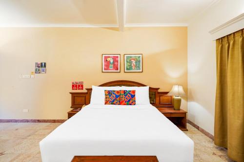 a bedroom with a large white bed in a room at FabHotel The Dayal - 24 kms from Delhi Gate, 5 kms from Agra Fort in Agra