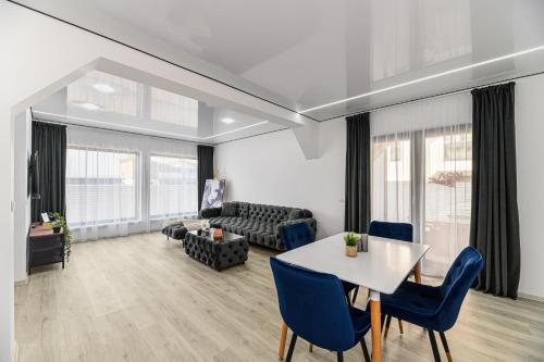 a living room with a table and chairs and a couch at KOA - Street in Braşov