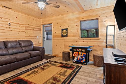 a living room with a couch and a table at The Cabin Kingdom Hot tub Fire Pit in Blairsville