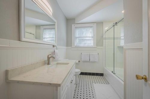 a white bathroom with a sink and a shower at Five Points Mill House w Firepit in Athens