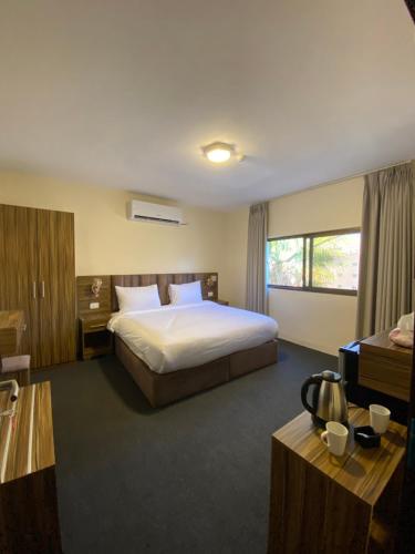 a hotel room with a bed and a window at Petra Jewel Hotel in Wadi Musa