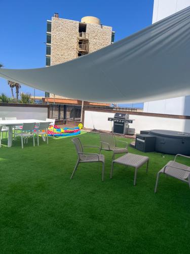 a group of chairs and tables on the grass at Briza in Netanya