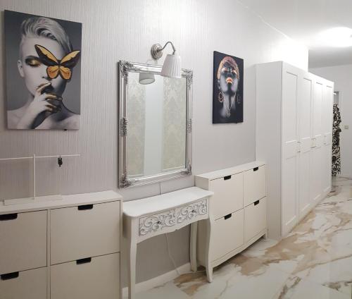 a bathroom with a sink and a mirror at Красив апартамент с целогодишен топъл басейн и джакузи in Varna City