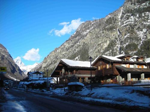 a log cabin in the mountains with snow on it at Apartment in Antey-Saint-André near Ski Lift in Antey-Saint-André