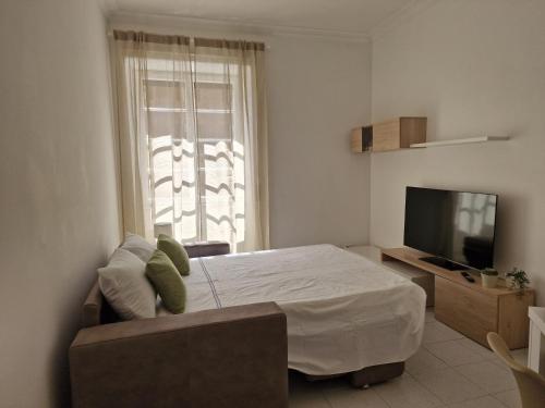 a bedroom with a large bed and a television at Alessandro's Home in Rome