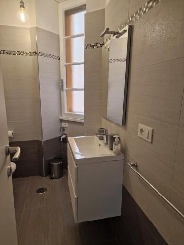 a bathroom with a sink and a mirror at Alessandro's Home in Rome