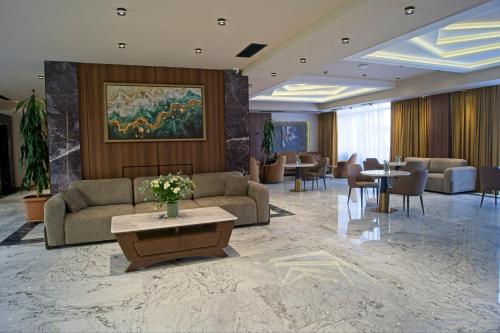 a hotel lobby with couches and tables and chairs at SIA Resort and SPA in Tsaghkadzor
