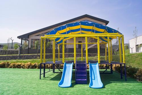 a playground with a yellow and blue play structure at SIA Resort and SPA in Tsaghkadzor