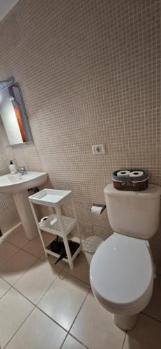 a bathroom with a toilet and a sink at Las Brisas in Granadilla de Abona