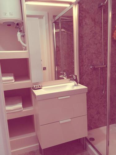 a bathroom with a sink and a shower at Casa dos Pátios II in Aveiro