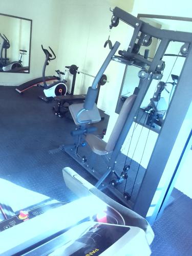 a gym with several treadmills and a mirror at Cozy comfort apartment in Lusaka
