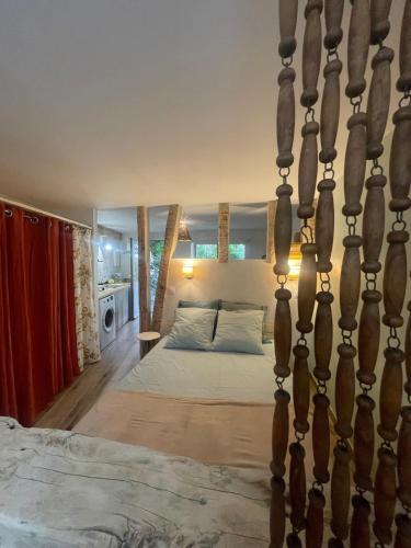 a bedroom with a large bed in a room at Studio Terrasse Le petit cabanon in Serres