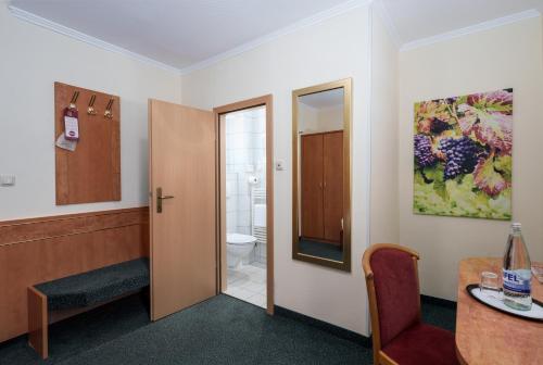 a room with a door to a bathroom with a toilet at Moselstern Hotel Brixiade &Triton in Cochem