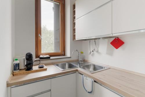 a kitchen with a sink and a window at GuestHost - Milano 2 Bright Apartment in Vimodrone