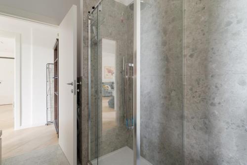 a glass shower in a bathroom with at GuestHost - Milano 2 Bright Apartment in Vimodrone