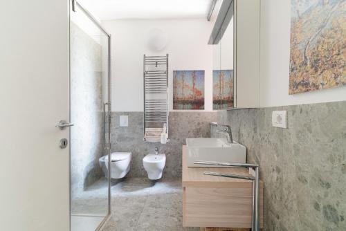 a bathroom with a sink and a toilet at GuestHost - Milano 2 Bright Apartment in Vimodrone
