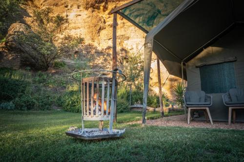 a bird cage with a fire in it in a yard at The Calitzdorp Station in Calitzdorp